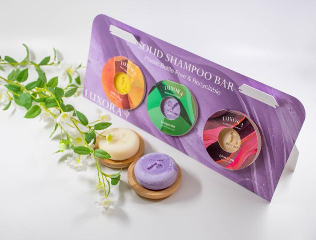 A package containing three shampoo bars, with purple packaging.
